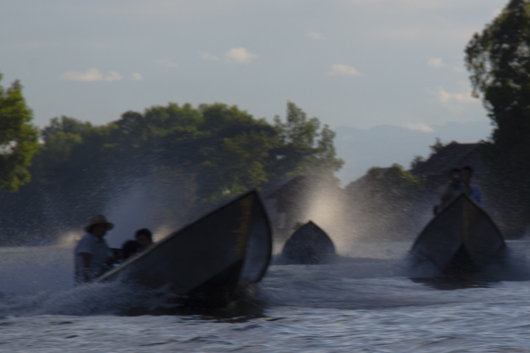 Long-tailed boats making a splash on Lake Inle in Myanmar