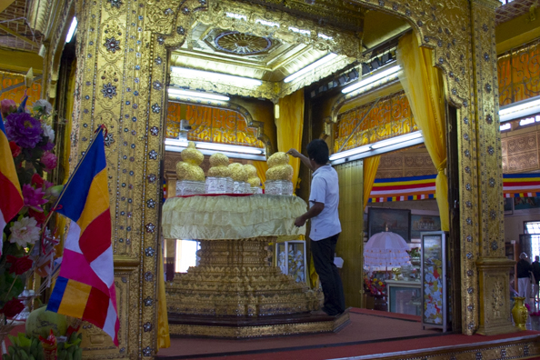 Putting gold leaf sheets on the images at Phaung-Daw-Oo-pagoda on Lake Inle
