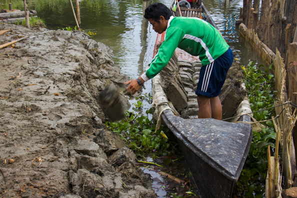 Enlarging the premises using blocks of mud on Lake Inle in Myanmar