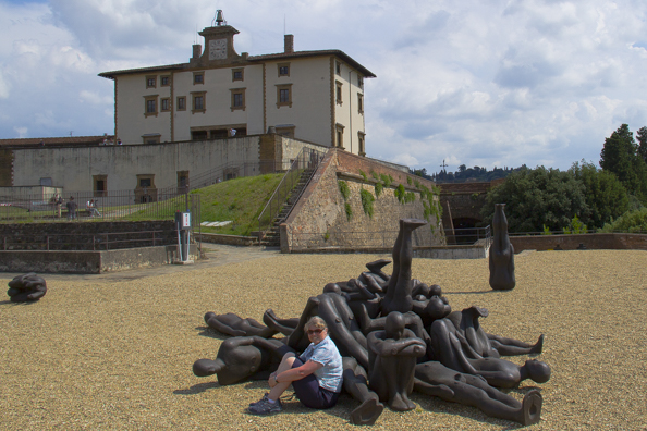 Posing with some bronze figures, work of Anthony Gormley outside Forte di Belvedere in Florence, Tuscany