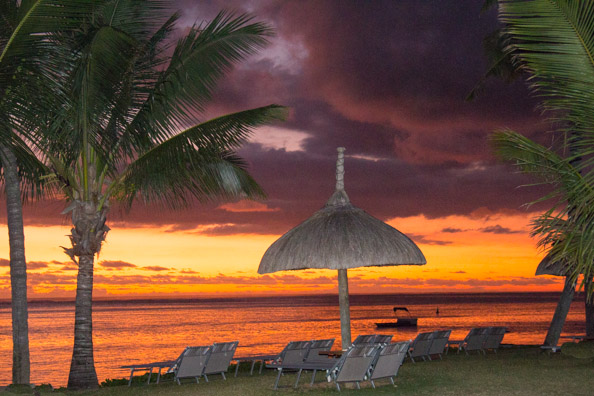 Sun setting over the beach of the Tamassa hotel in Bel Ombre on Mauritius
