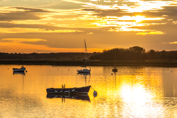 Sun setting over the River Alde in Aldeburgh in Suffolk, UK