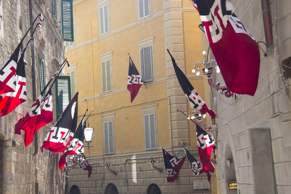 The flags are out celebrating success in the Palio race in Siena, Tuscany in Italy