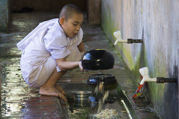 Washing the alms bowls at Mahaganayon Buddhist monastery in Myanmar